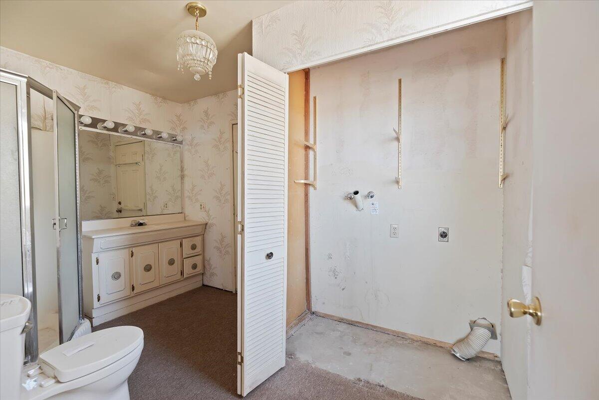 61313 El Coyote Lane Joshua Tree, CA 92252 - Photo 18 of 48 a bathroom with a granite countertop sink toilet and shower