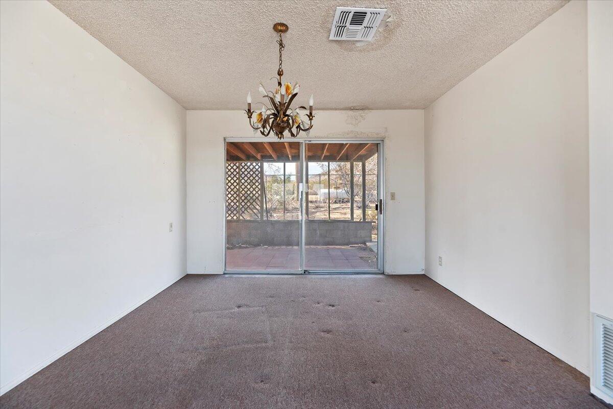 61313 El Coyote Lane Joshua Tree, CA 92252 - Photo 20 of 48 a view of a livingroom with a chandelier fan