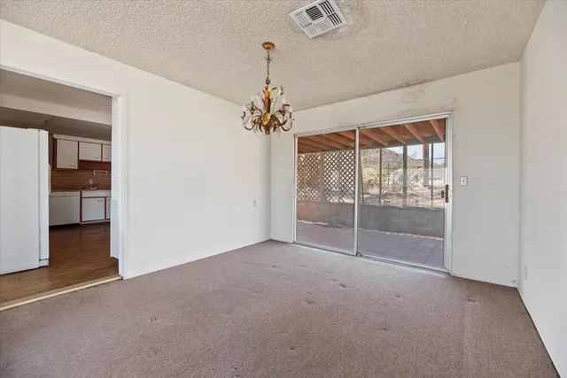 a kitchen with stainless steel appliances cabinets and wooden floor