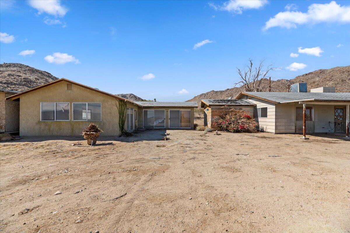 61313 El Coyote Lane Joshua Tree, CA 92252 - Photo 32 of 48 a front view of a house with a yard and garage