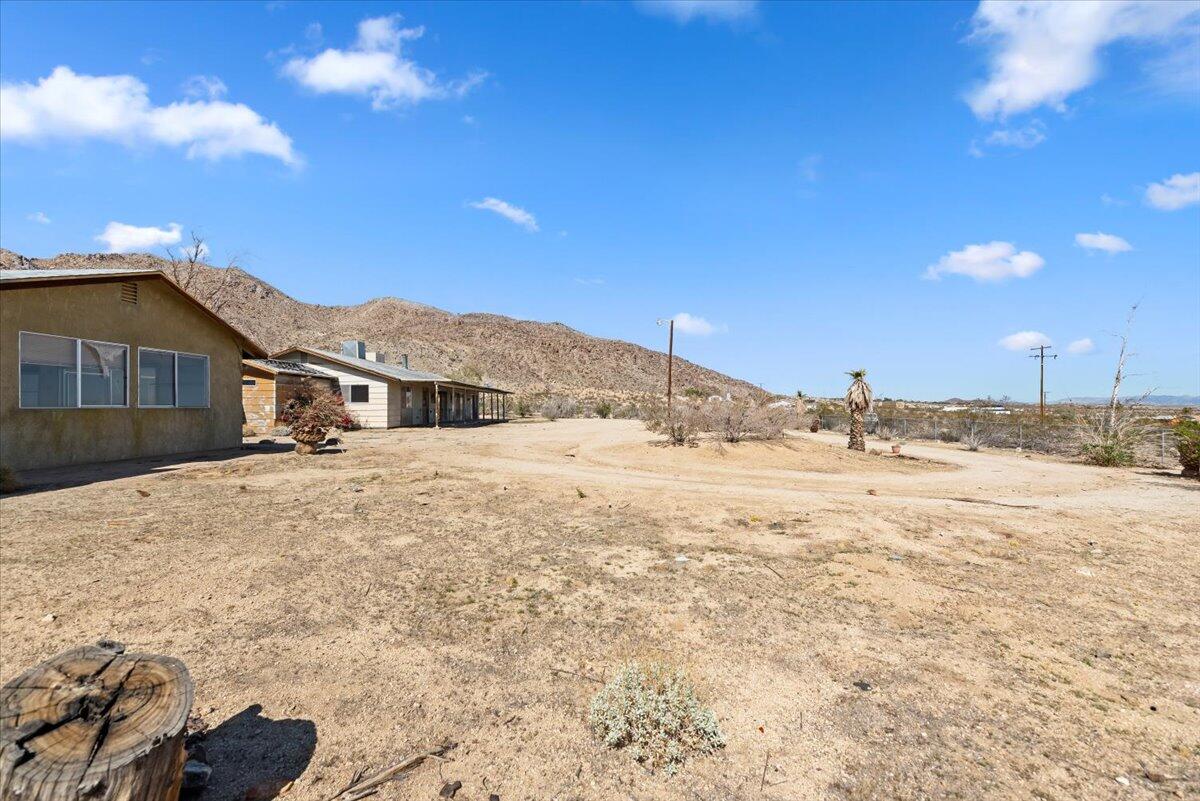 61313 El Coyote Lane Joshua Tree, CA 92252 - Photo 42 of 48 a view of a house with a yard