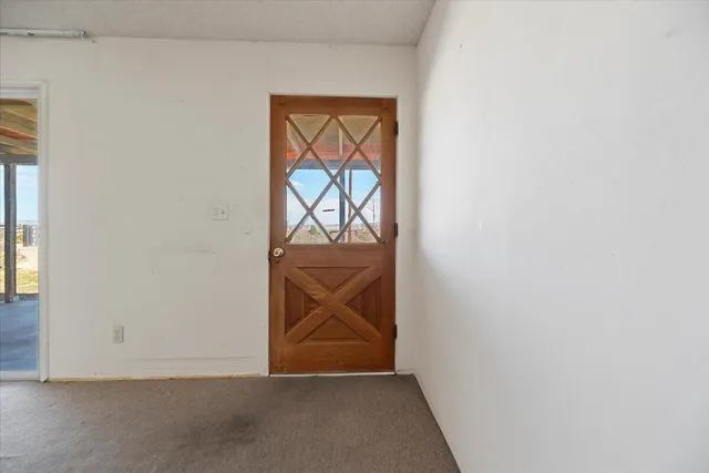 an empty room with wooden floor and closet