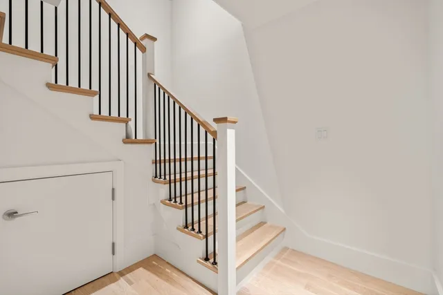 a view of entryway with wooden floor and stairs