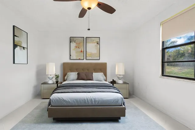 a bedroom with a bed and painting on the wall