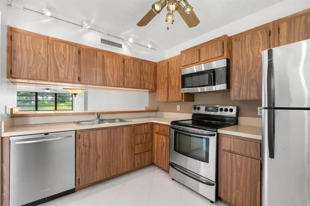 a kitchen with a sink stove and microwave