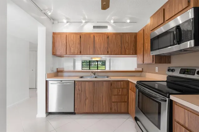 a kitchen with a sink stove and microwave