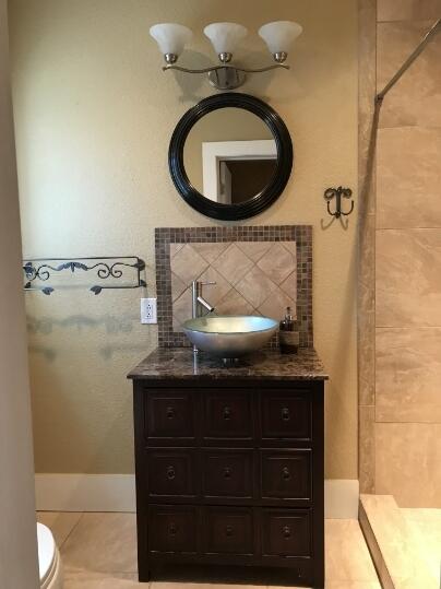 2311 16th Street Lubbock, TX 79401 - Photo 16 of 30 a bathroom with a granite countertop sink and a mirror
