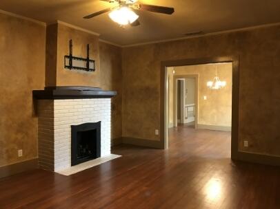 2311 16th Street Lubbock, TX 79401 - Photo 4 of 30 a view of an empty room with wooden floor and a fireplace