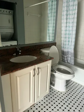 a bathroom with a sink a toilet and a mirror