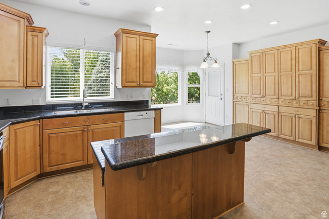 2190 750 West Perry, UT 84302 - Photo 21 of 42 Kitchen featuring wood cabinetry, dark countertops, a central island with countertop seating, and recessed lighting