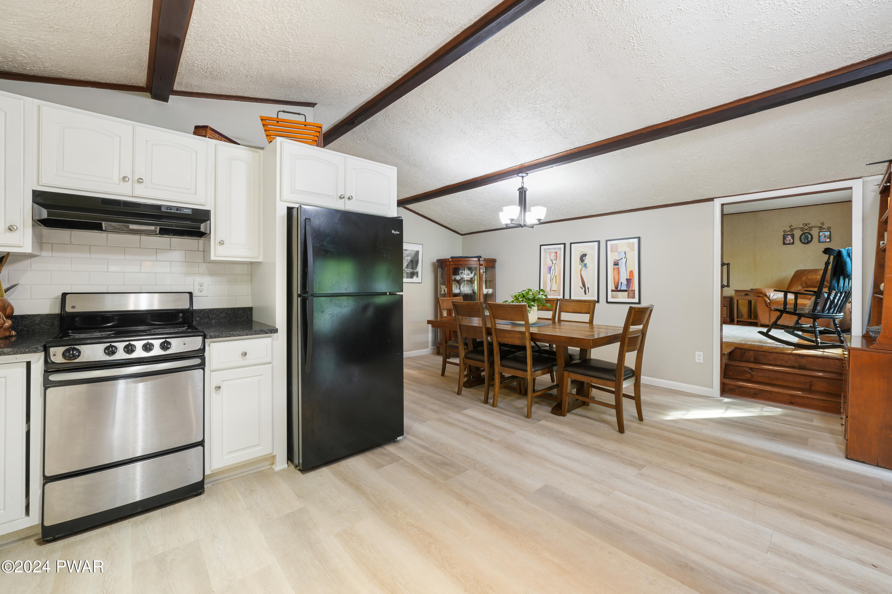 130 Beech Road Dingmans Ferry, PA 18328 - Photo 20 of 31 a kitchen with stainless steel appliances kitchen island granite countertop a table chairs and a refrigerator