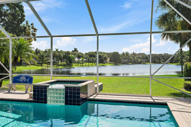 a dining room with a floor to ceiling window and wooden floor