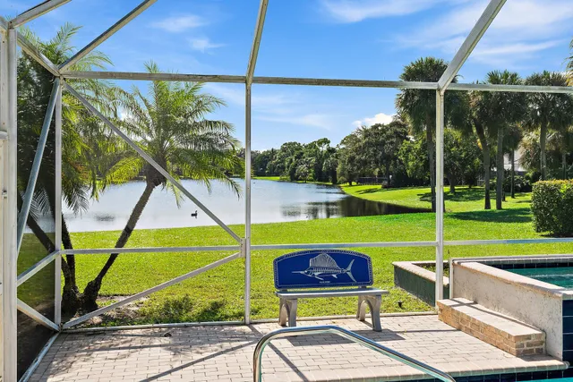 a kitchen with white cabinets appliances and a window