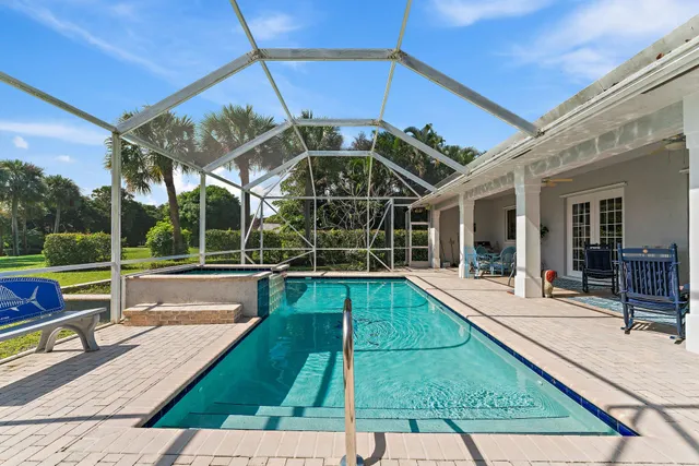 a bedroom with a bed and a lamp on the dresser