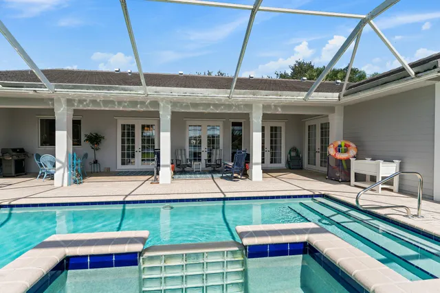 a spacious bedroom with a bed and a dresser in it