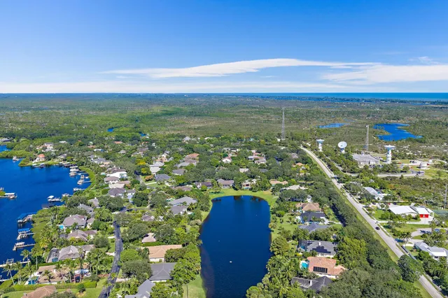 a front view of a house with a garden and yard