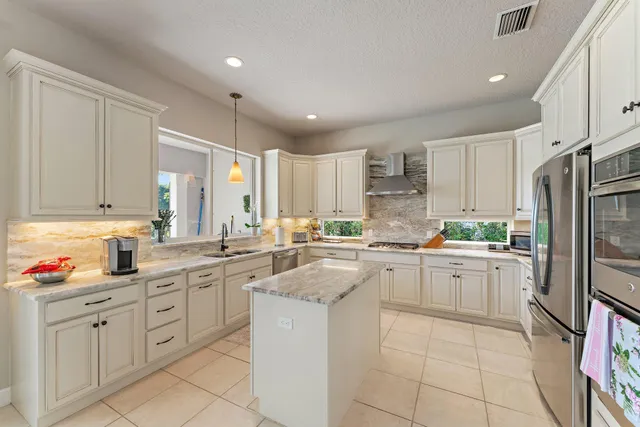 a bedroom with a bed next to a window