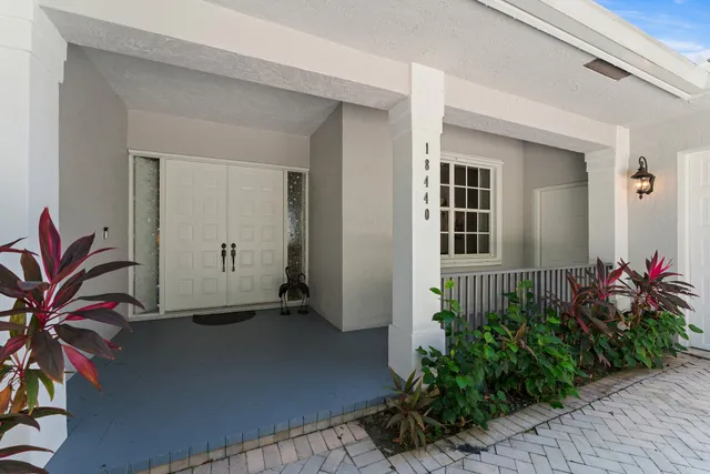 a living room with furniture kitchen view and a large window