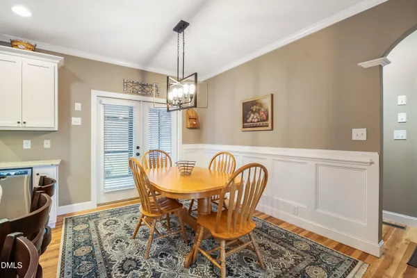 a kitchen with stainless steel appliances kitchen island granite countertop a sink a stove a refrigerator and chairs