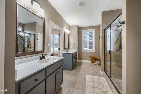 a spacious bedroom with a bed and a dresser