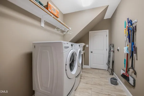 a bathroom with a glass shower door and a window