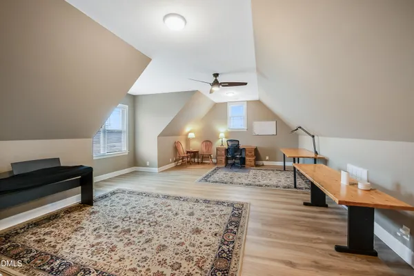 a view of a workspace with furniture and a window