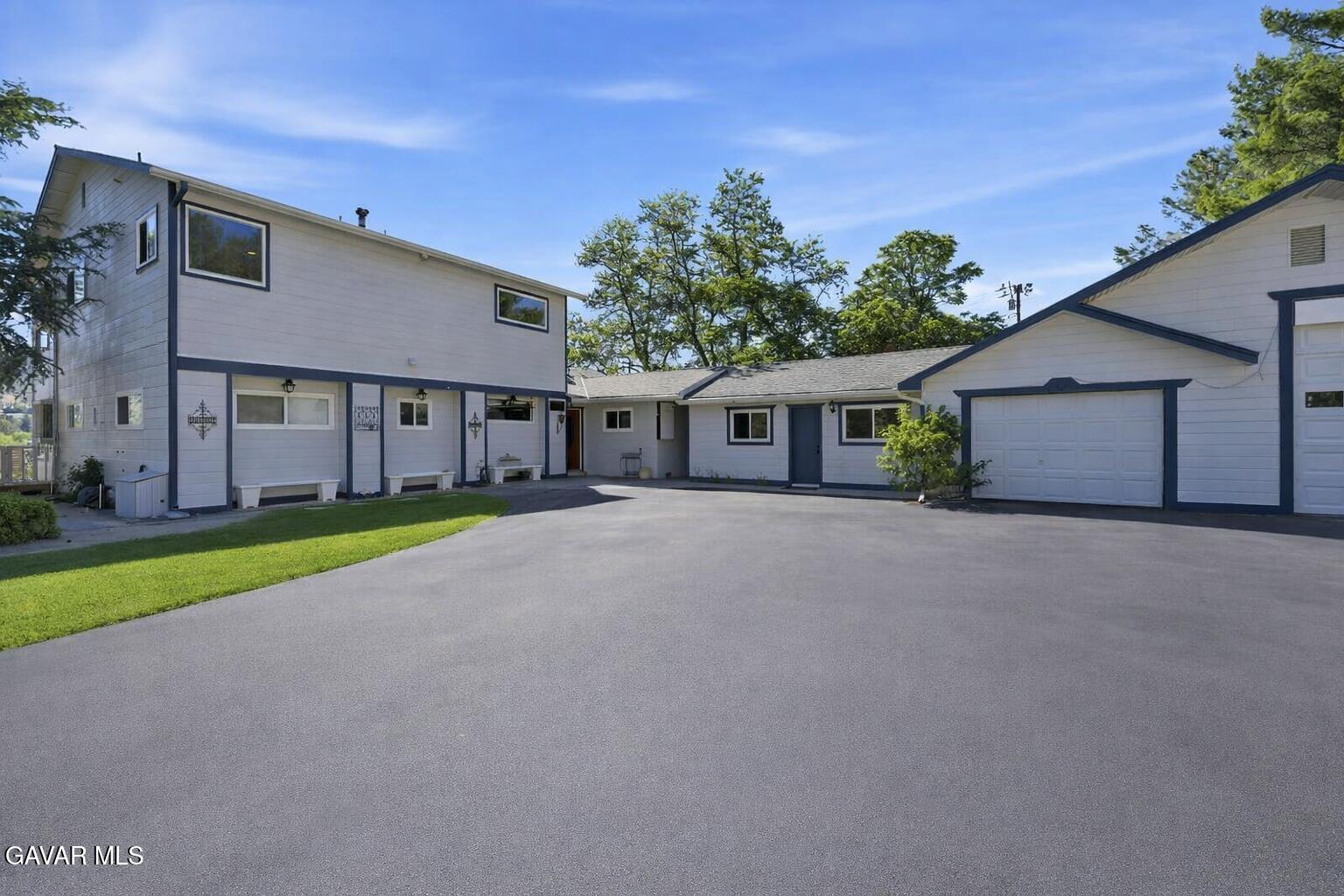 9065 Elizabeth Lake Road Leona Valley, CA 93551 - Photo 13 of 58 a view of a house with a yard and garage