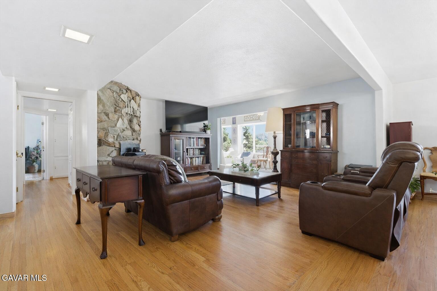 9065 Elizabeth Lake Road Leona Valley, CA 93551 - Photo 15 of 58 a living room with furniture and a wooden floor