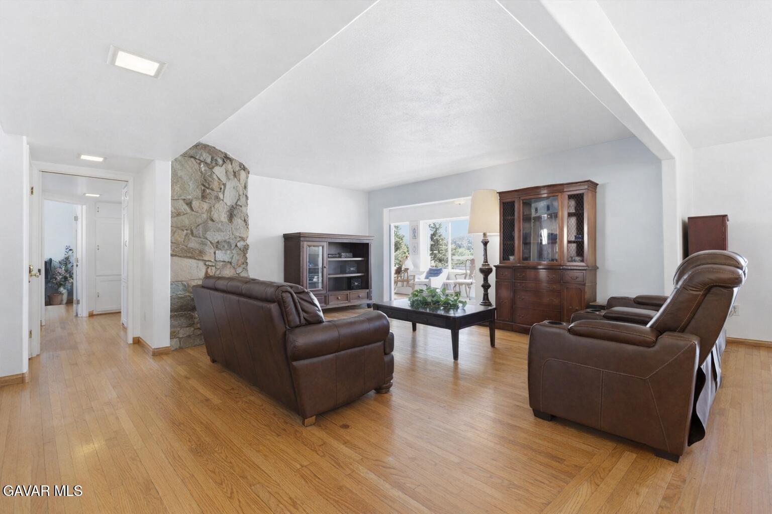 9065 Elizabeth Lake Road Leona Valley, CA 93551 - Photo 18 of 58 a living room with furniture and a fireplace