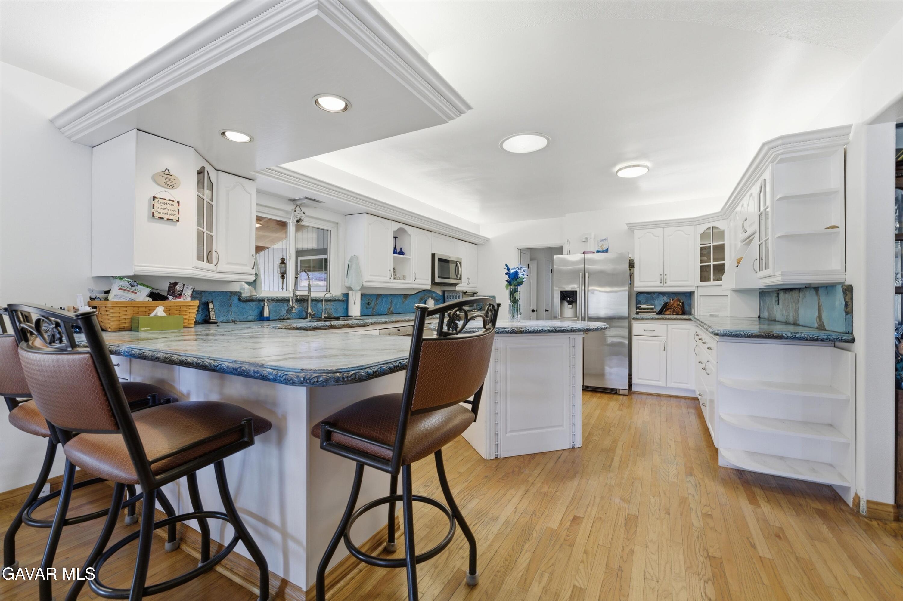 9065 Elizabeth Lake Road Leona Valley, CA 93551 - Photo 21 of 58 a living room with stainless steel appliances kitchen island granite countertop furniture and a kitchen view