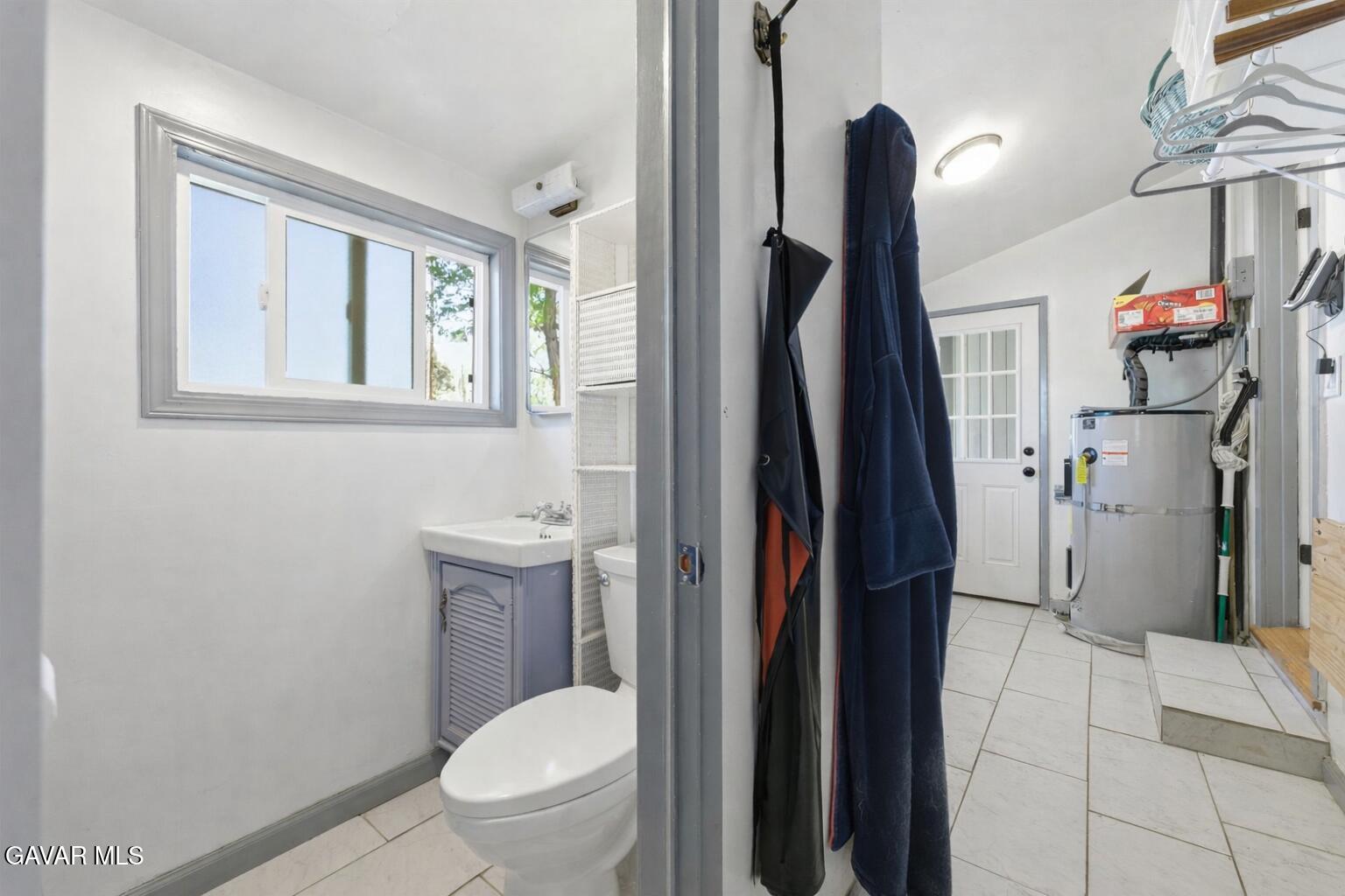 9065 Elizabeth Lake Road Leona Valley, CA 93551 - Photo 25 of 58 a bathroom with a toilet sink and mirror