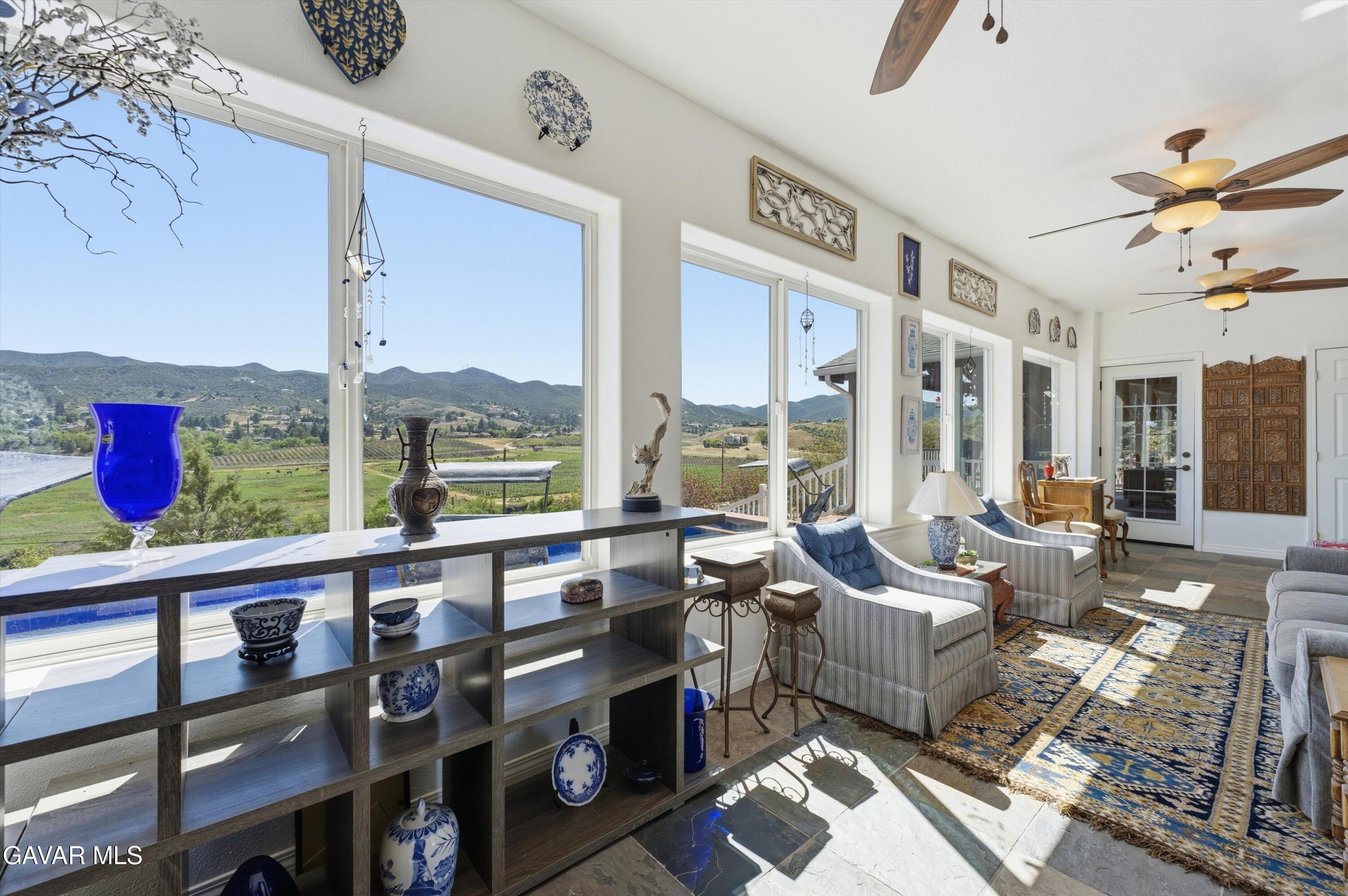 9065 Elizabeth Lake Road Leona Valley, CA 93551 - Photo 34 of 58 a living room with furniture and a floor to ceiling window