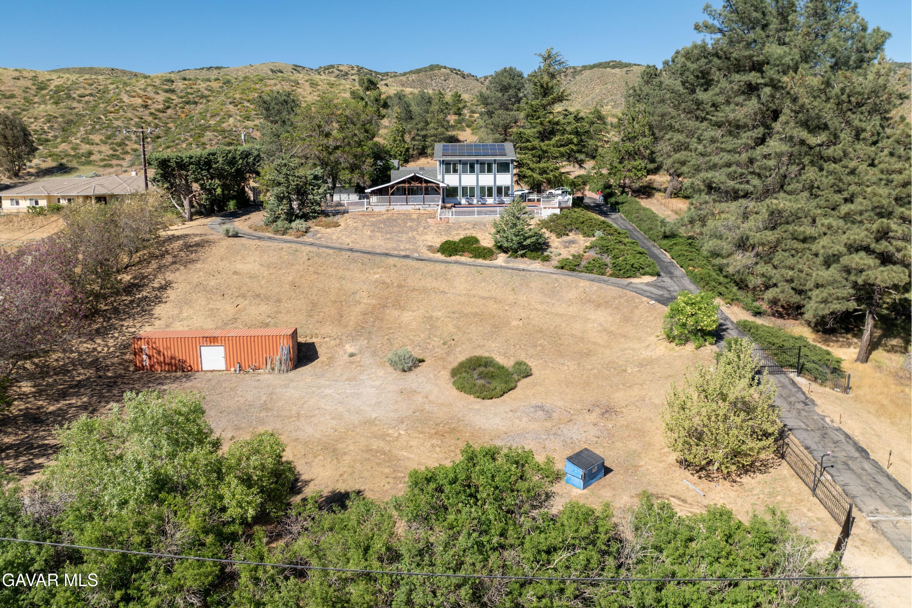 9065 Elizabeth Lake Road Leona Valley, CA 93551 - Photo 43 of 58 a view of a house with a yard