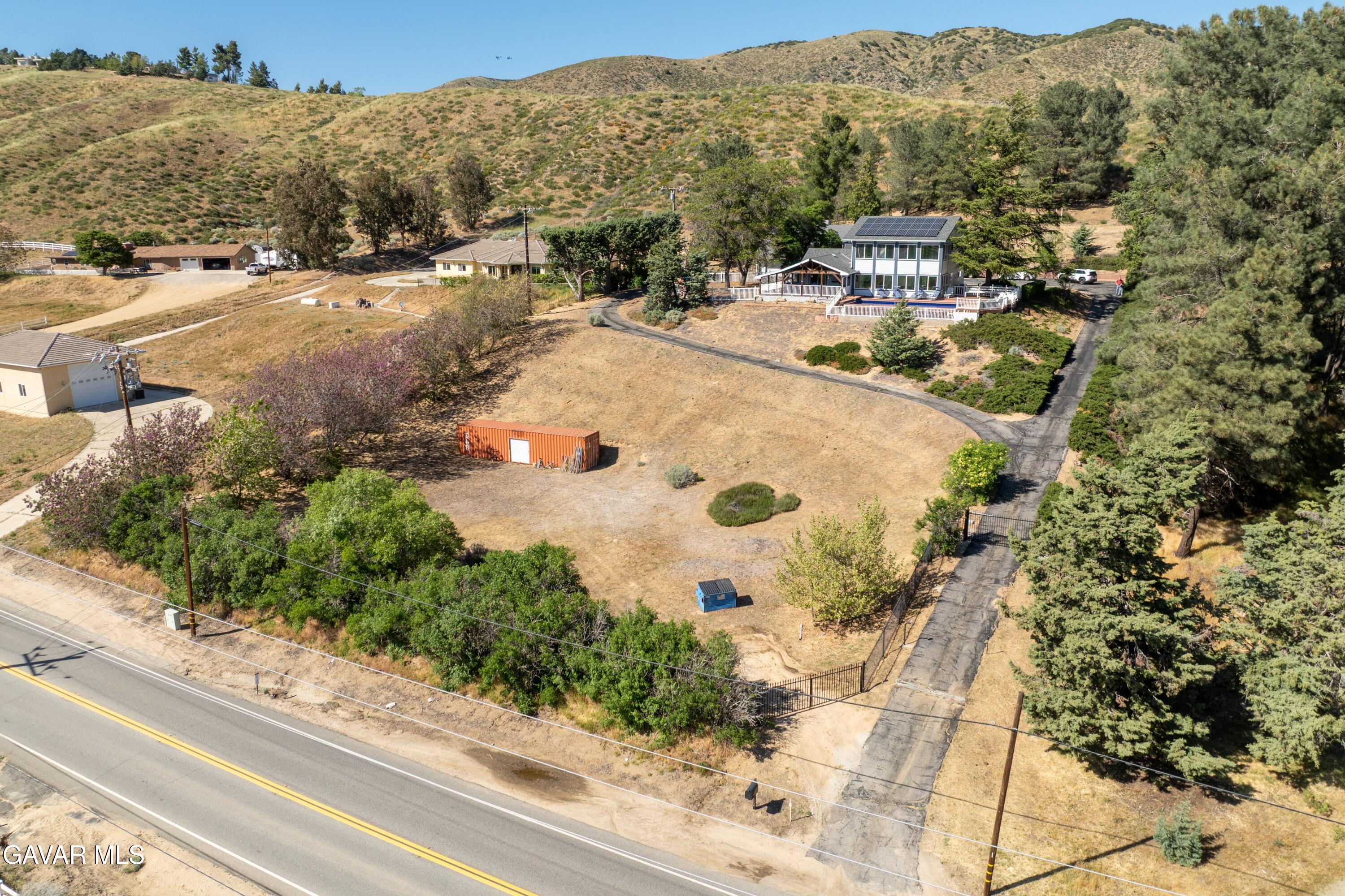 9065 Elizabeth Lake Road Leona Valley, CA 93551 - Photo 44 of 58 a view of a backyard of a house