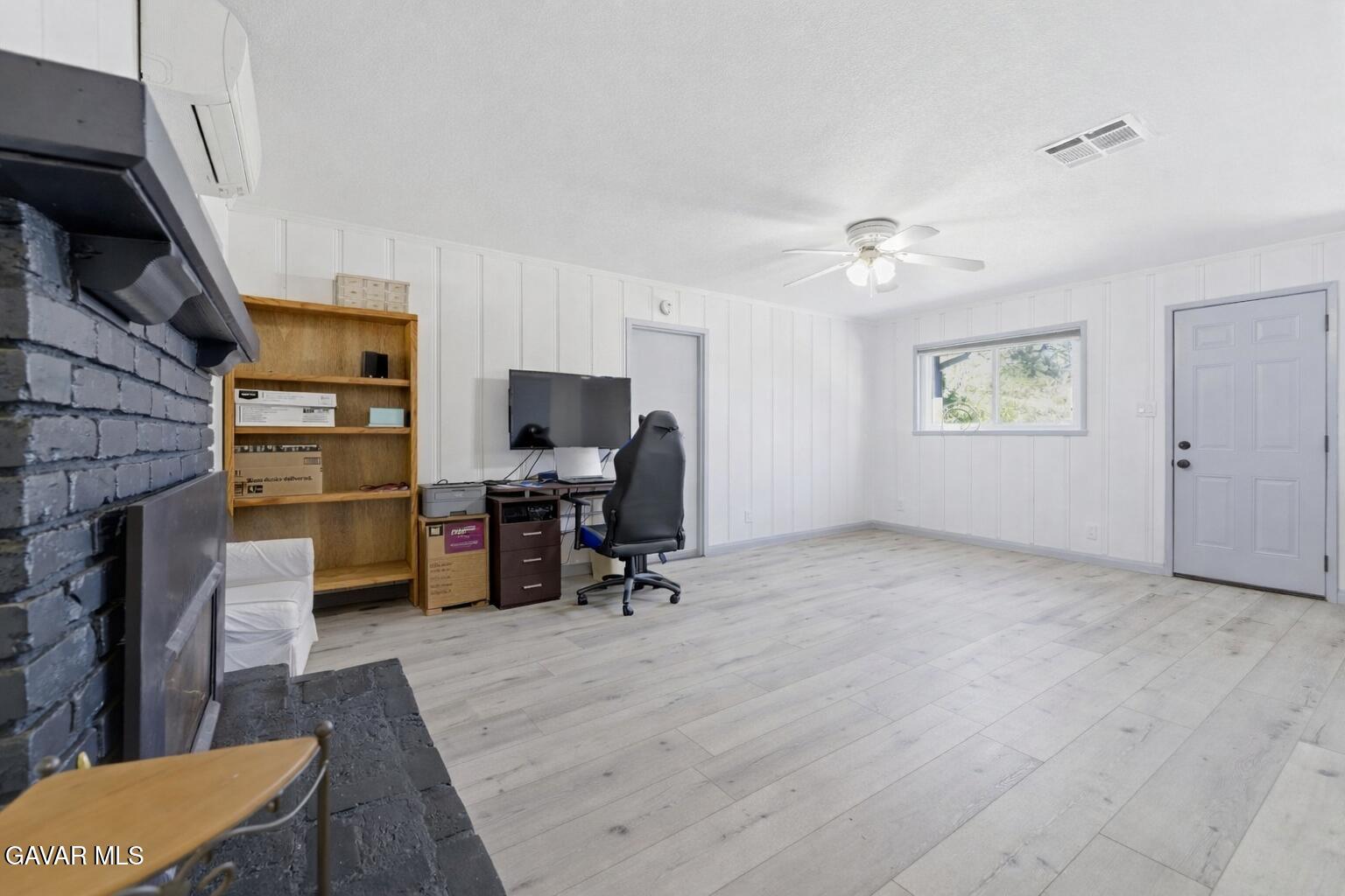 9065 Elizabeth Lake Road Leona Valley, CA 93551 - Photo 51 of 58 a view of a livingroom with workspace and a window