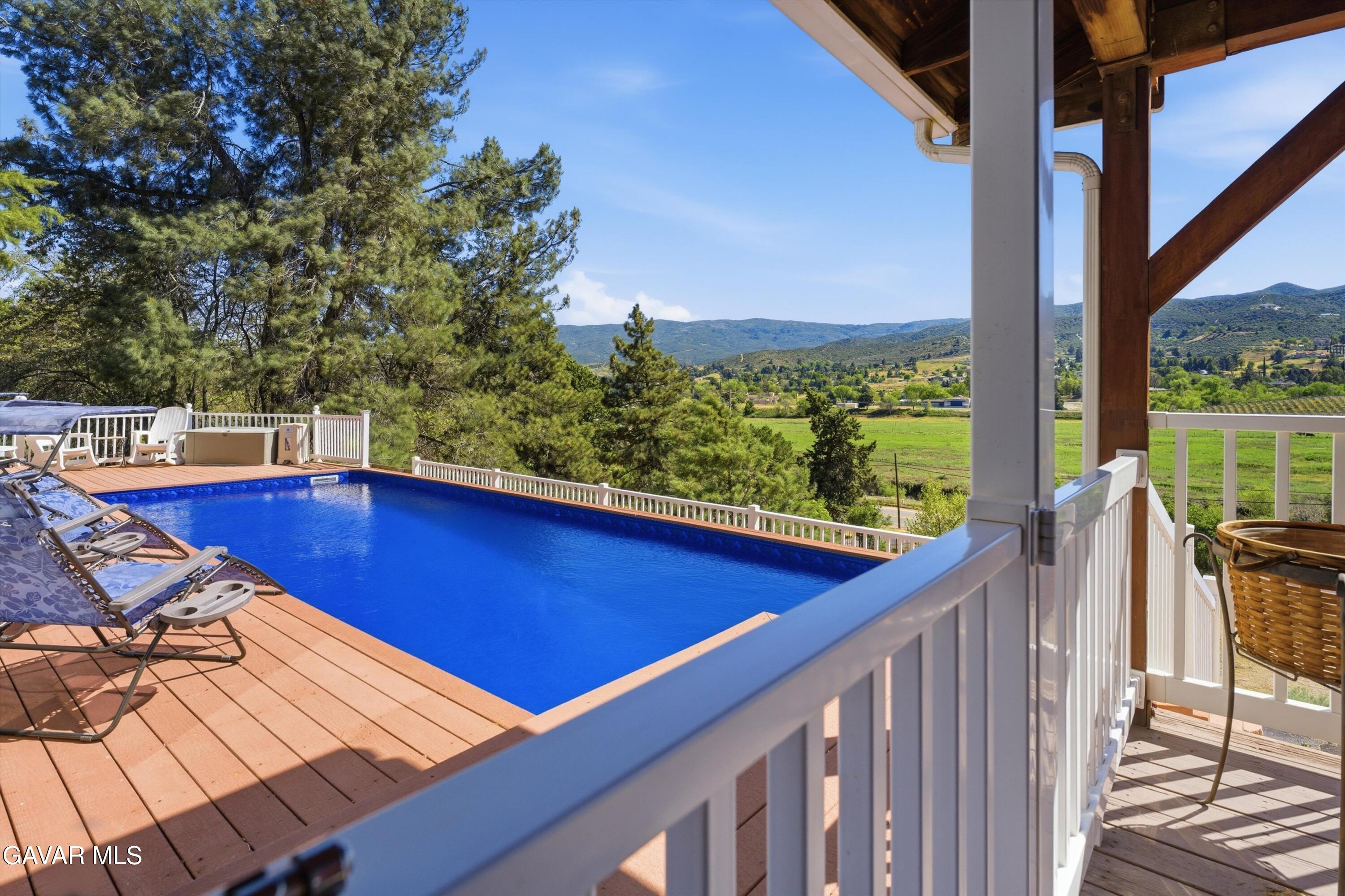 9065 Elizabeth Lake Road Leona Valley, CA 93551 - Photo 52 of 58 a view of a balcony with mountain view and wooden floor