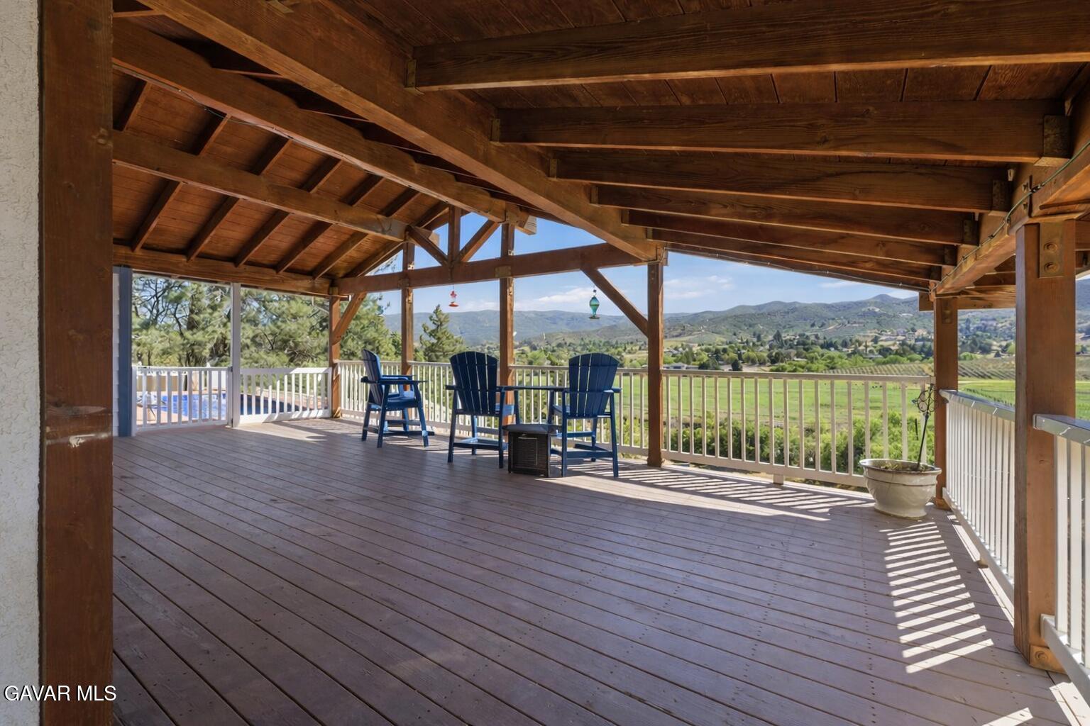 9065 Elizabeth Lake Road Leona Valley, CA 93551 - Photo 55 of 58 a patio with wooden floor a yard tables and chairs