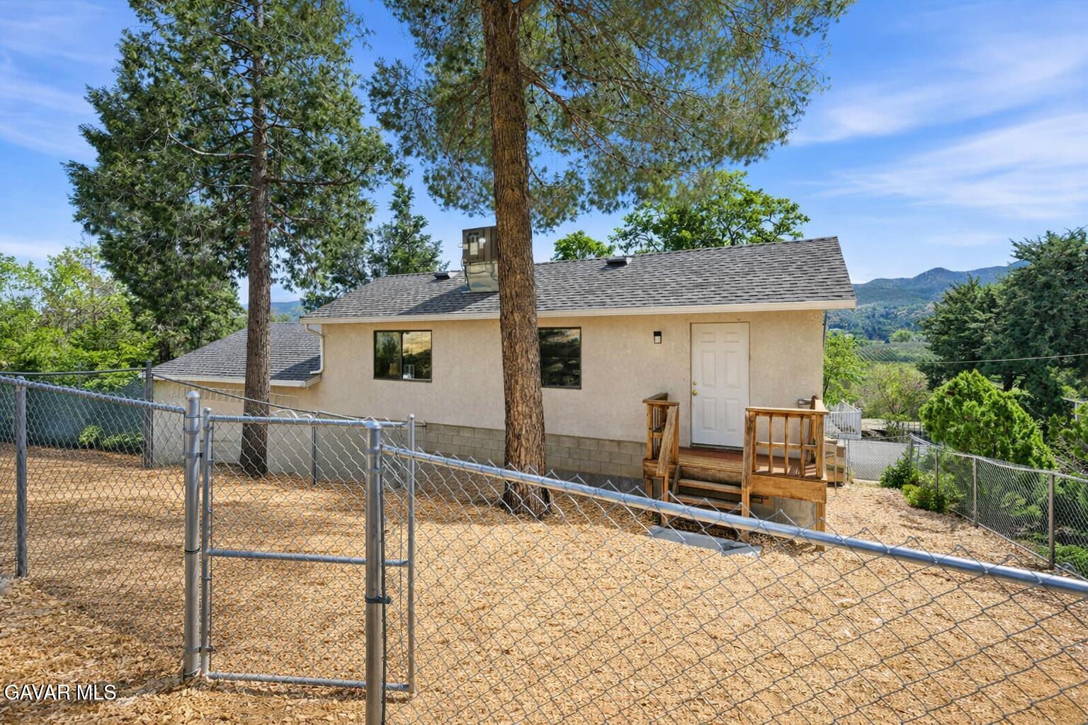 9065 Elizabeth Lake Road Leona Valley, CA 93551 - Photo 56 of 58 a view of a house with backyard and sitting area