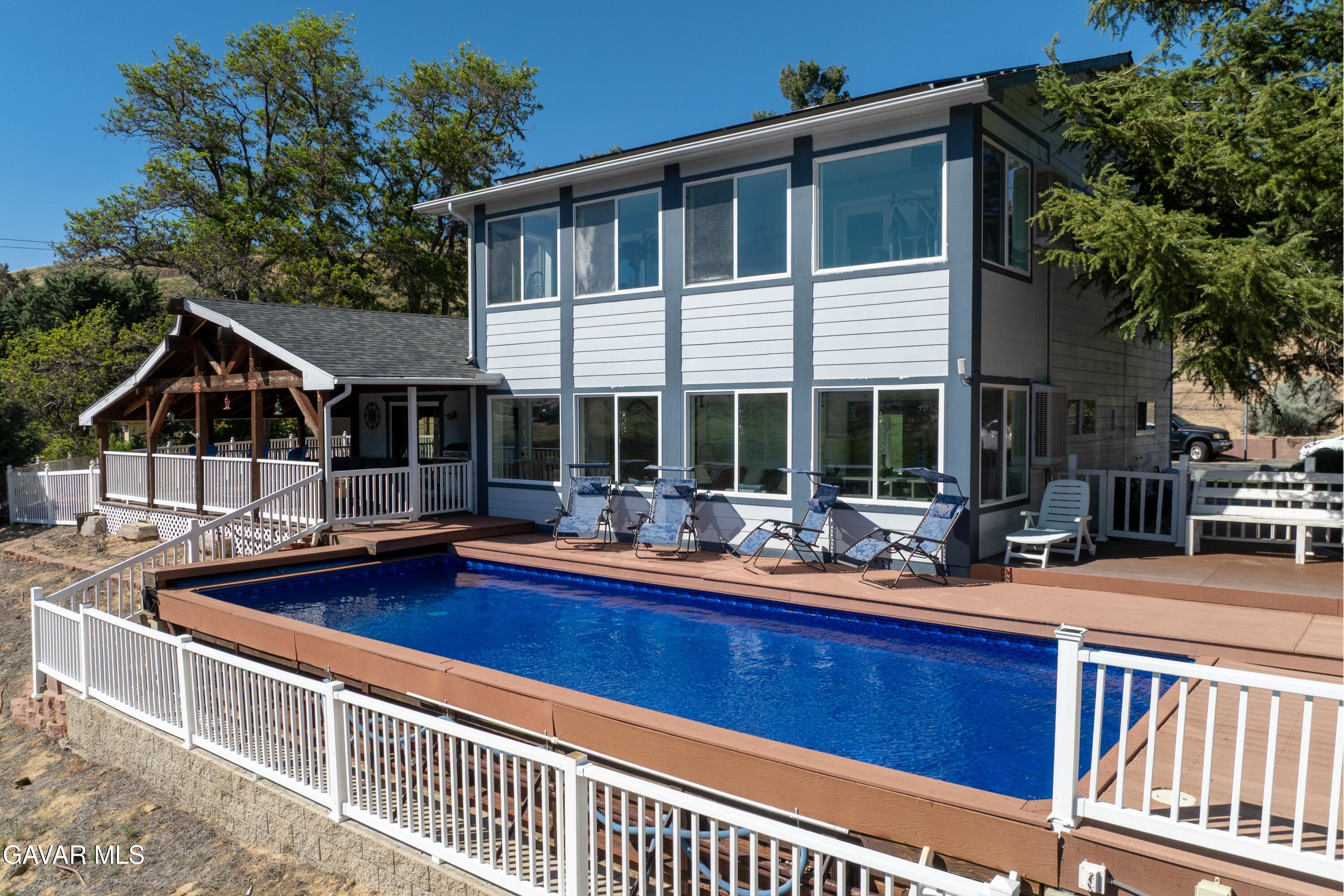 9065 Elizabeth Lake Road Leona Valley, CA 93551 - Photo 7 of 58 a front view of house with yard and outdoor seating