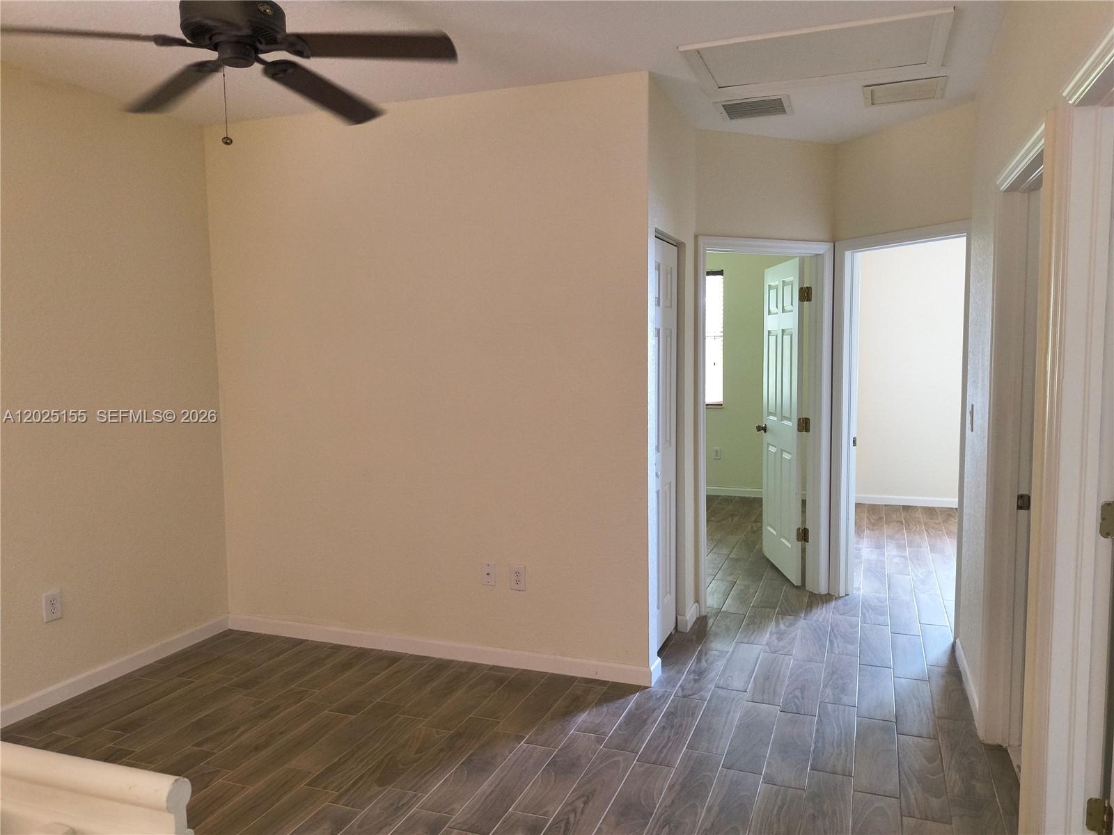 1645 Southeast 20th Road, Unit 1645 Homestead, FL 33035 - Photo 11 of 20 a view of a room with wooden floor closet and windows