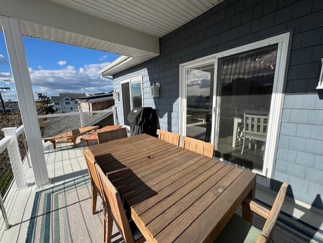 5 East Sumner Avenue Strathmere, NJ 08248 - Photo 25 of 35 a view of a patio with table and chairs with wooden floor and fence