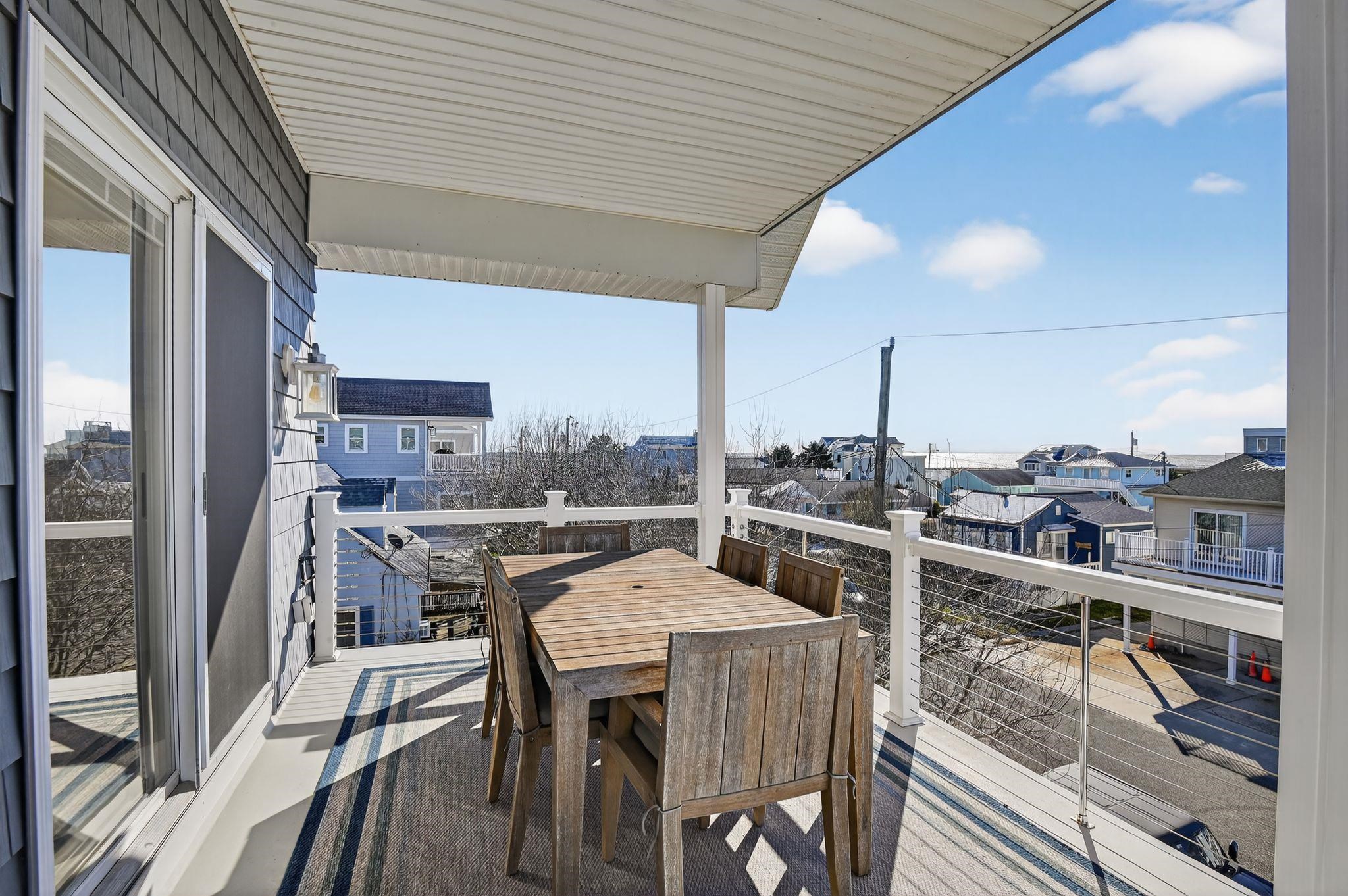 5 East Sumner Avenue Strathmere, NJ 08248 - Photo 5 of 35 a view of a roof deck with table and chairs