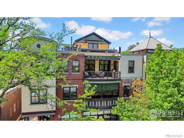 a balcony with furniture and potted plants