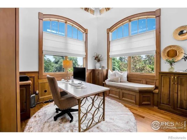 a roof deck with table and chairs and potted plants