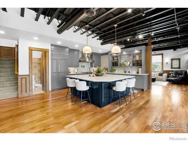 a dining hall with stainless steel appliances kitchen island a chandelier