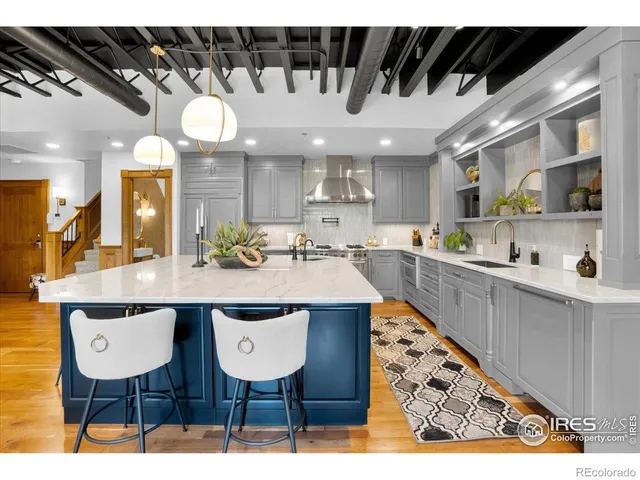 a kitchen with stainless steel appliances kitchen island granite countertop a sink and cabinets
