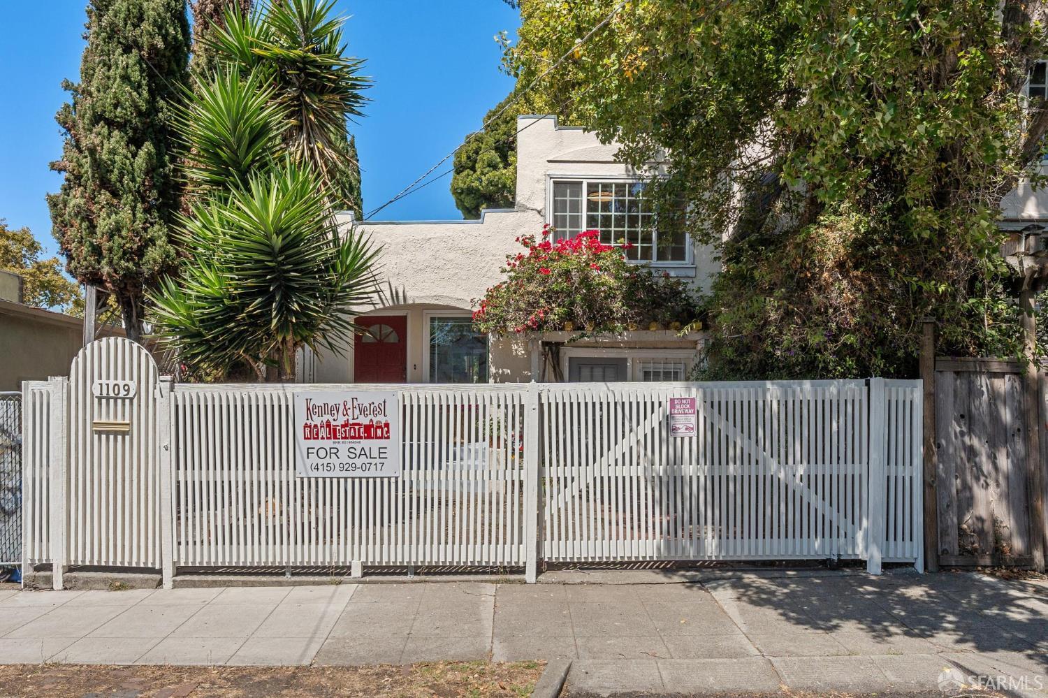 a front view of a house with iron fence