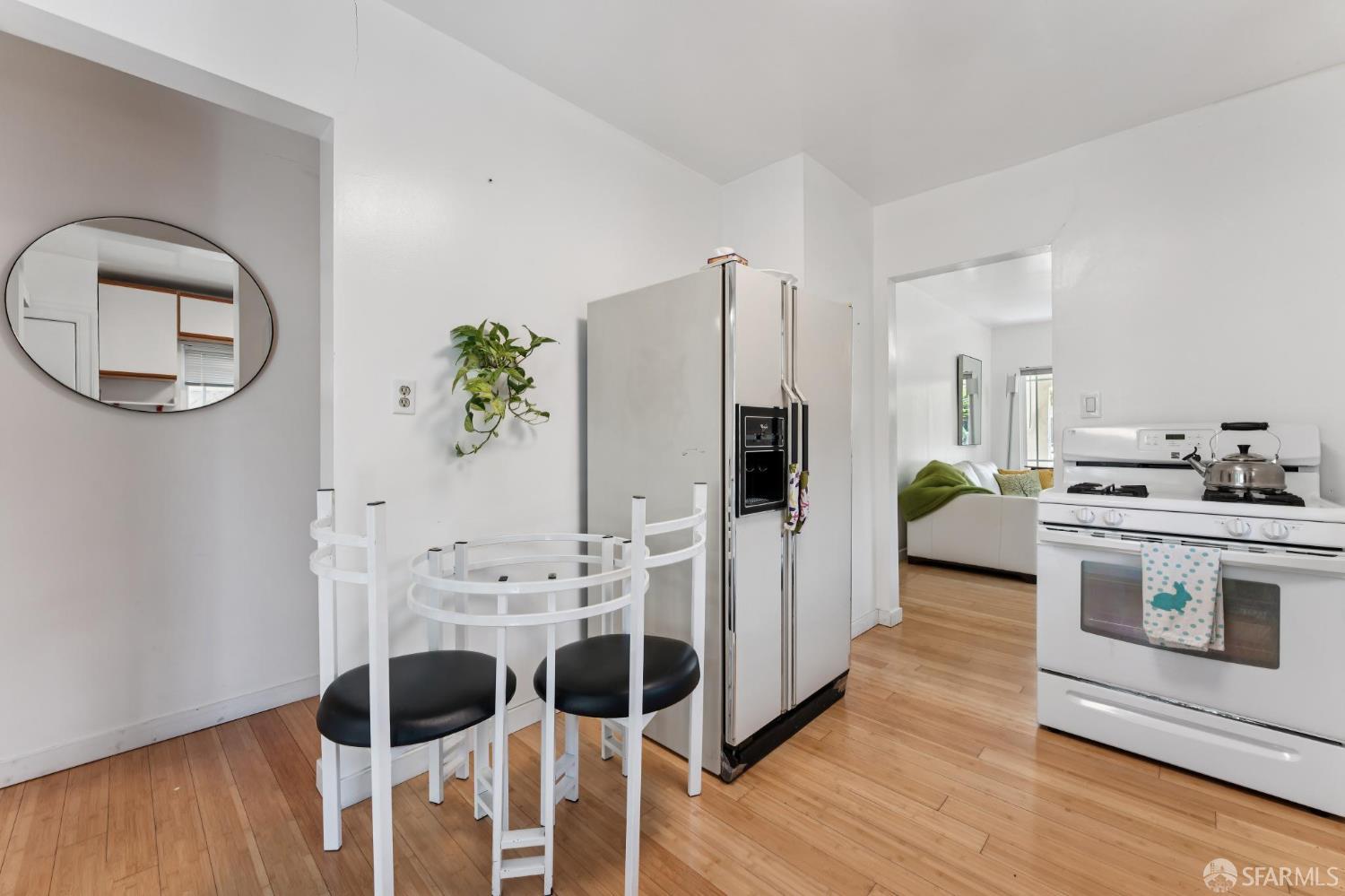 1109 Channing Way Berkeley, CA 94702 - Photo 9 of 24 a kitchen with stainless steel appliances a stove a table and chairs