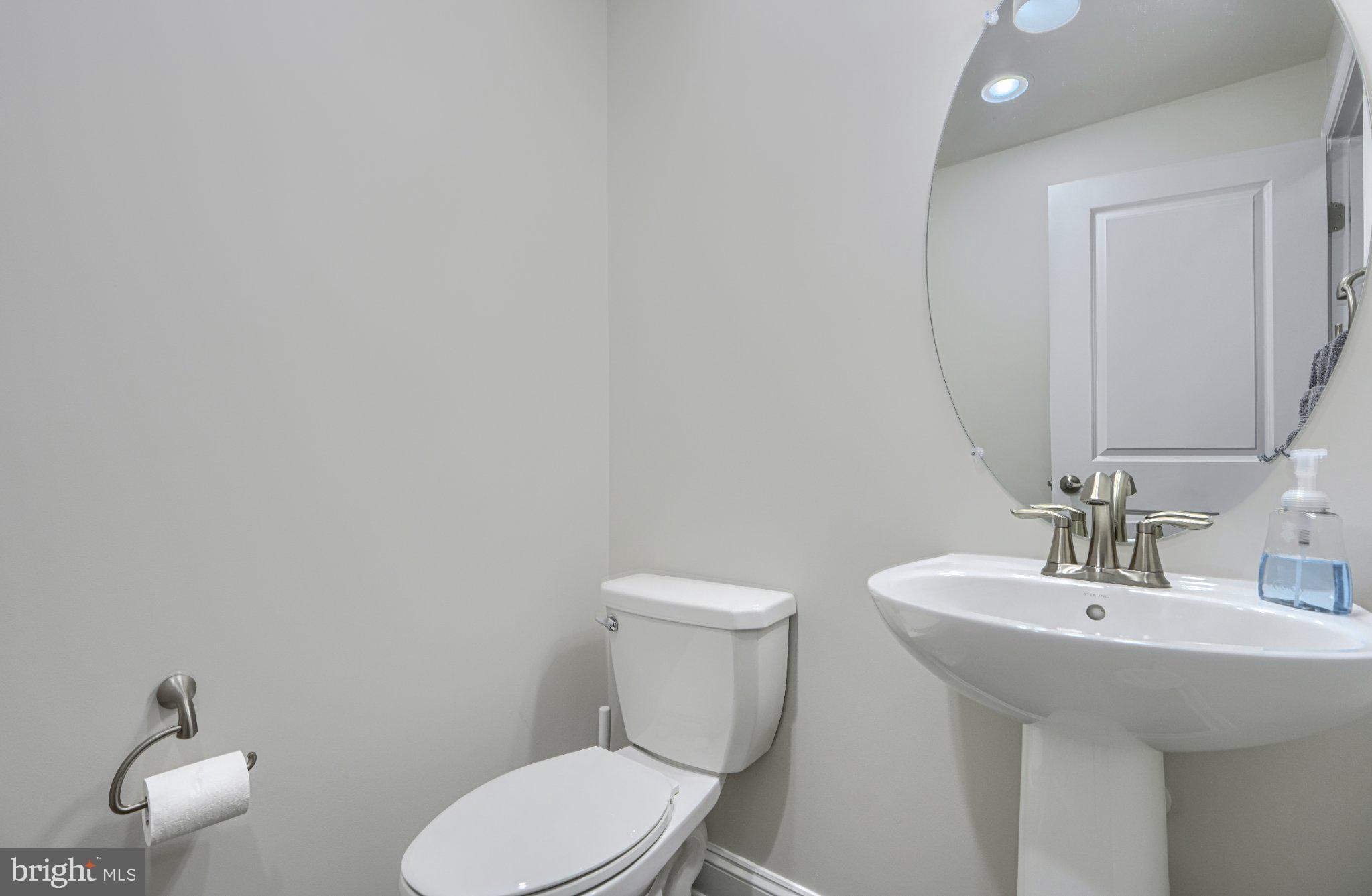 2707 Lady Slipper Road Gambrills, MD 21054 - Photo 23 of 60 a bathroom with a toilet a sink and mirror