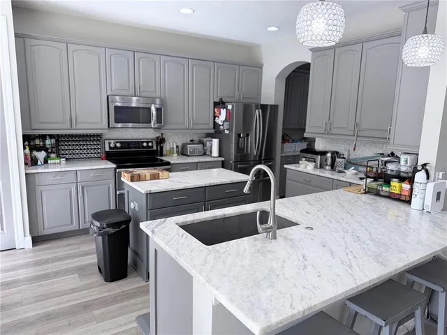 a kitchen with a sink a stove and cabinets